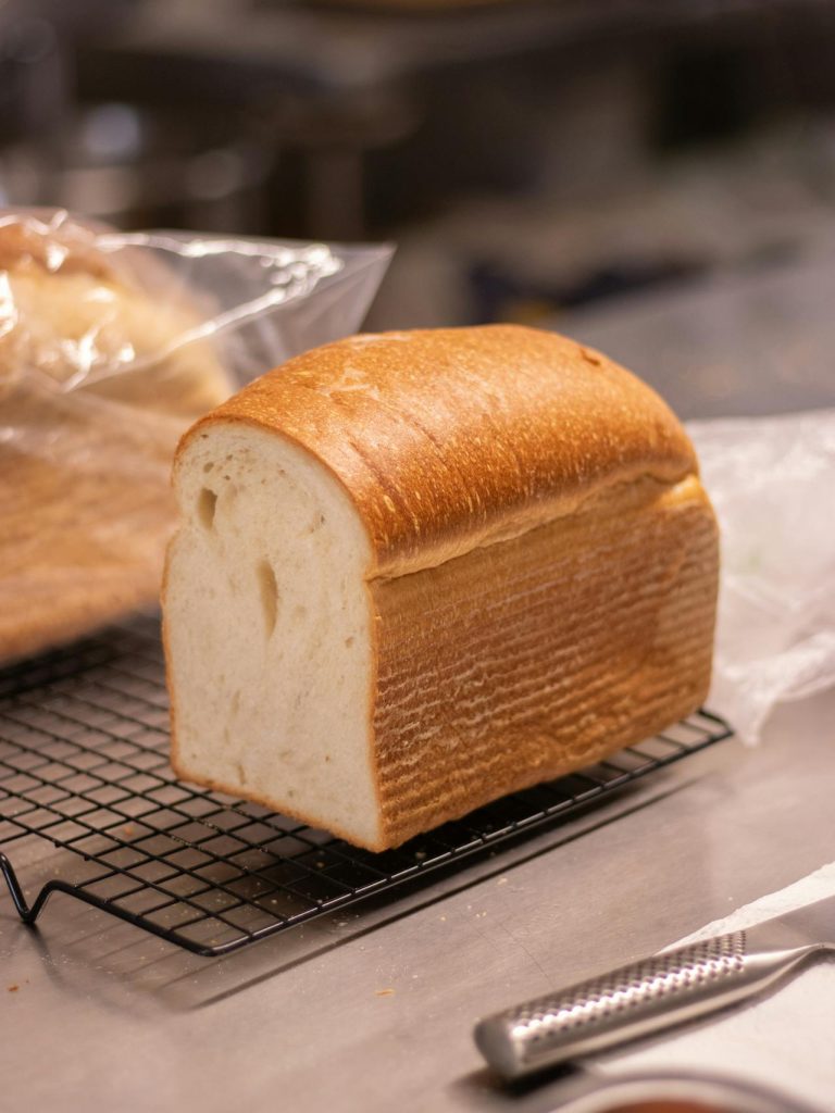 Freshly baked loaf of bread on a cooling rack